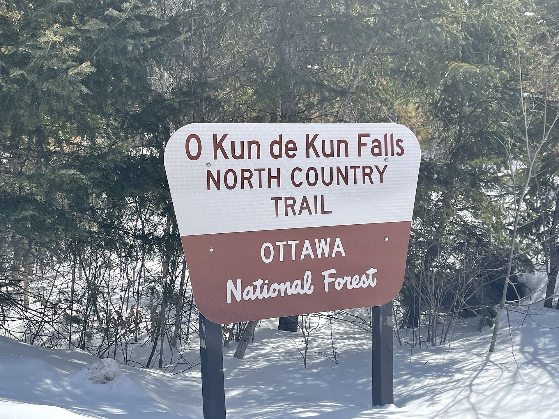 Sign at the entrance to O Kun de Kun Falls, located within the forest